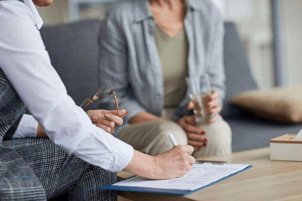 Therapist noting down the patients answers