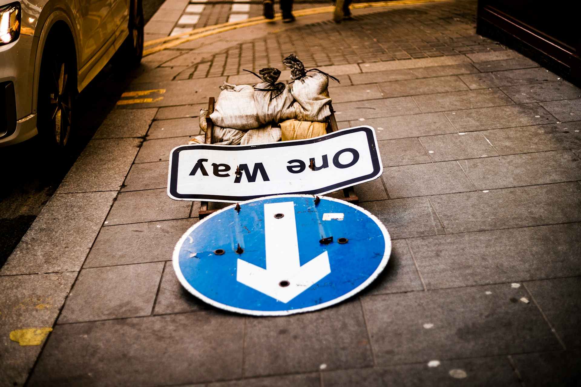 one way sign fall on floor indicating forward through setbacks